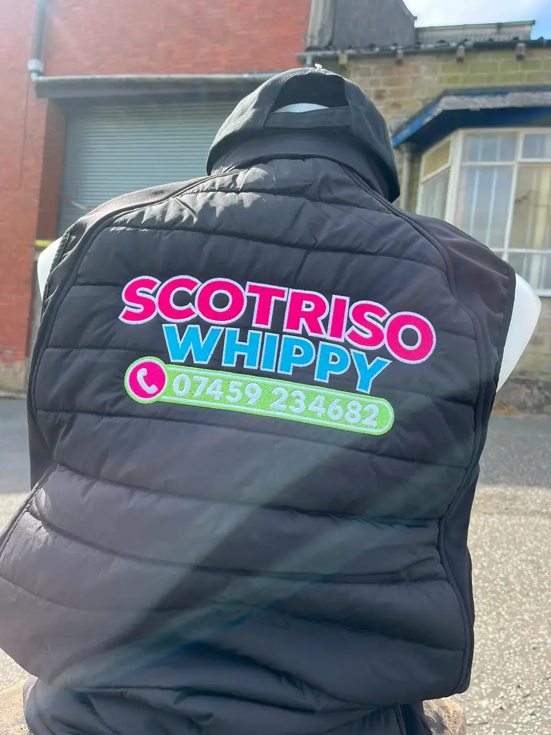 Black gilet printed with large Scotriso Whippy lettering on the back
