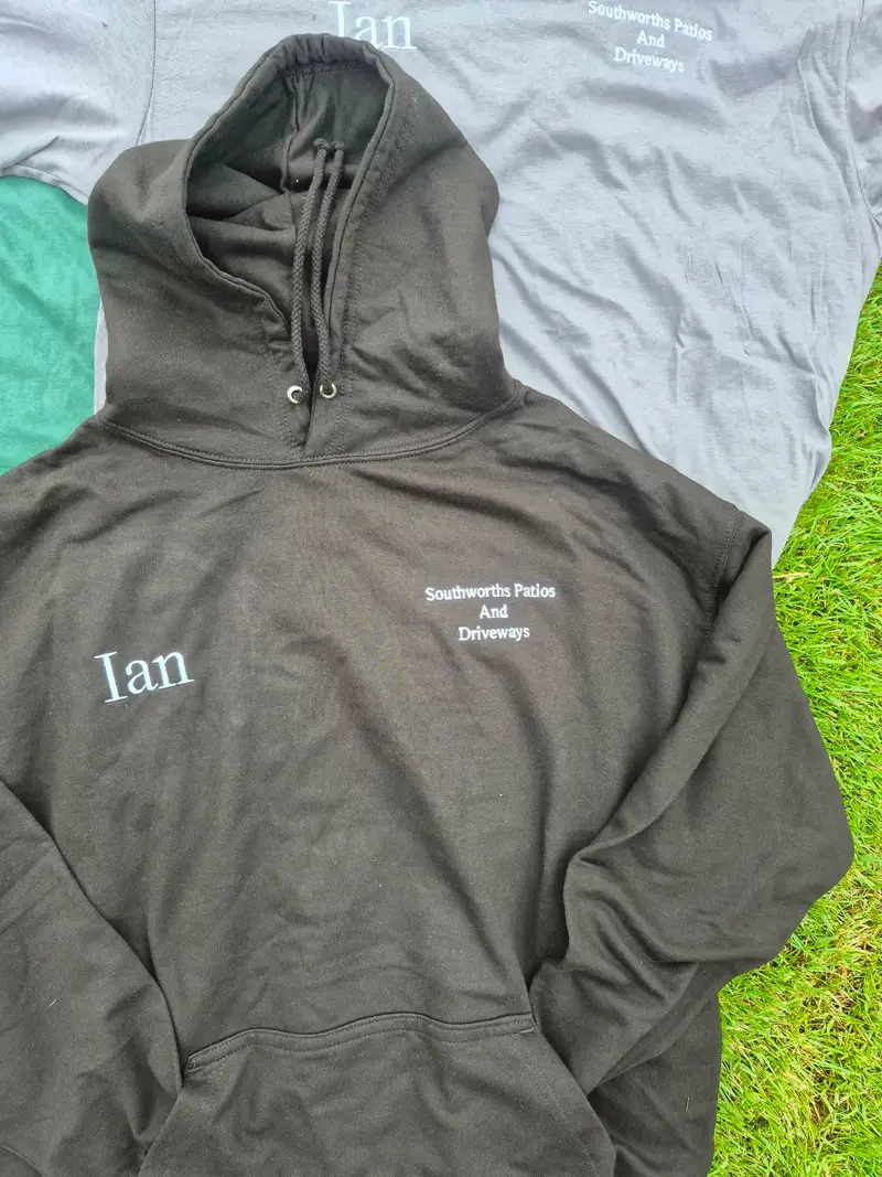 Black hoodie and grey t-shirt embroidered for Southworths Patios and Driveways with the name Ian