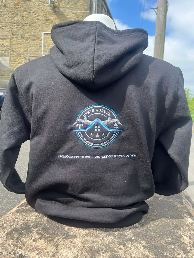 Black hoodie embroidered with a roofing company badge and strapline
