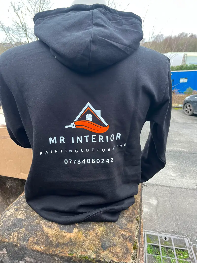 Black hoodie printed with the Mr Interior logo on the back