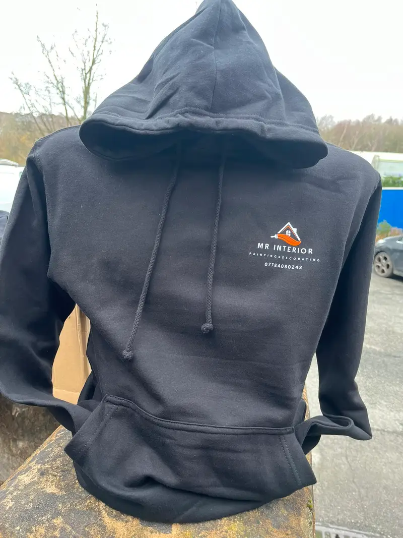 Black hoodie with a small printed Mr Interior logo on the chest