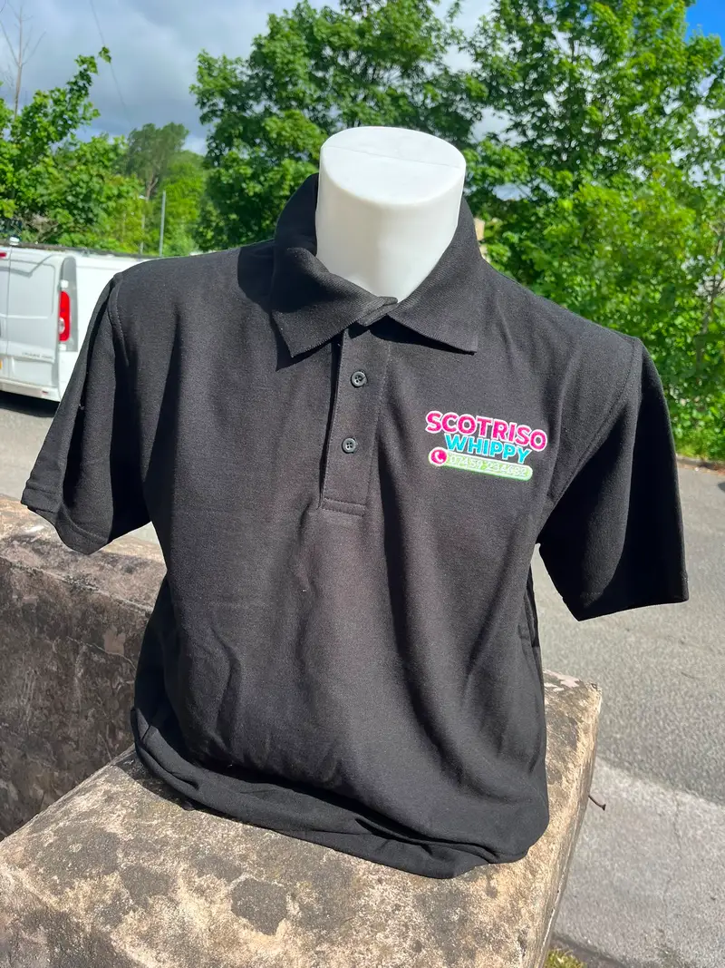 Black polo shirt embroidered with the Scotriso Whippy logo