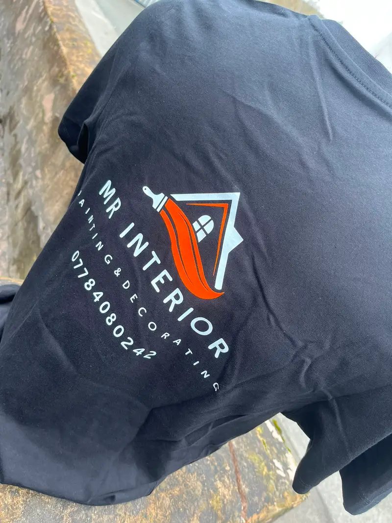 Black t-shirt printed with the Mr Interior logo and phone number