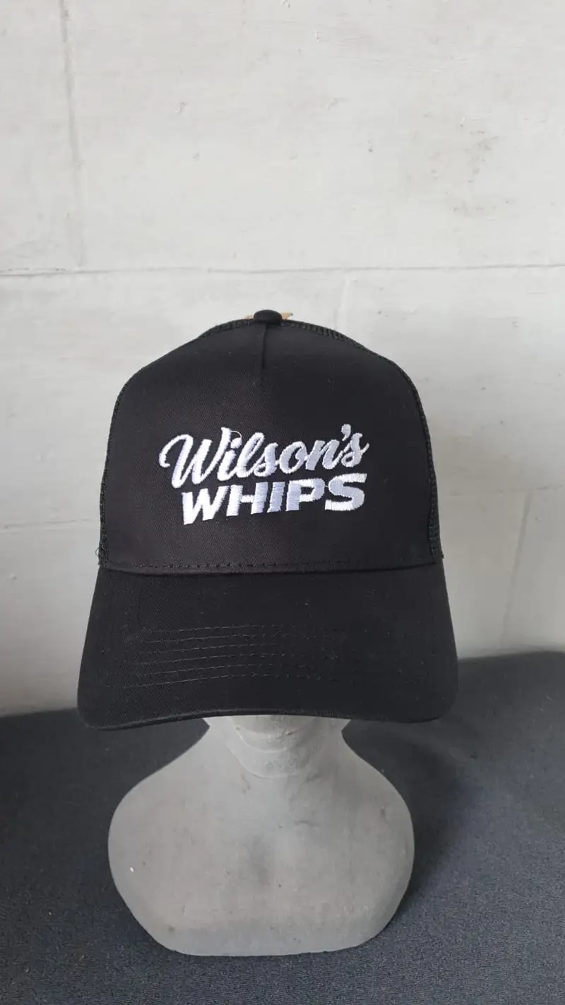 Black trucker cap embroidered with the Wilson's Whips logo