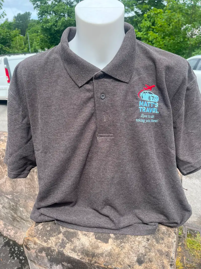 Brown polo shirt embroidered with the Matt's Travel car and plane logo