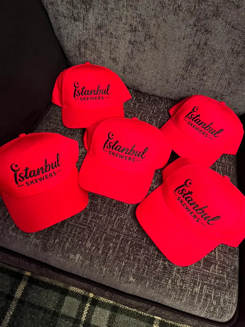 Five red trucker caps embroidered in Colne for Istanbul Skewers