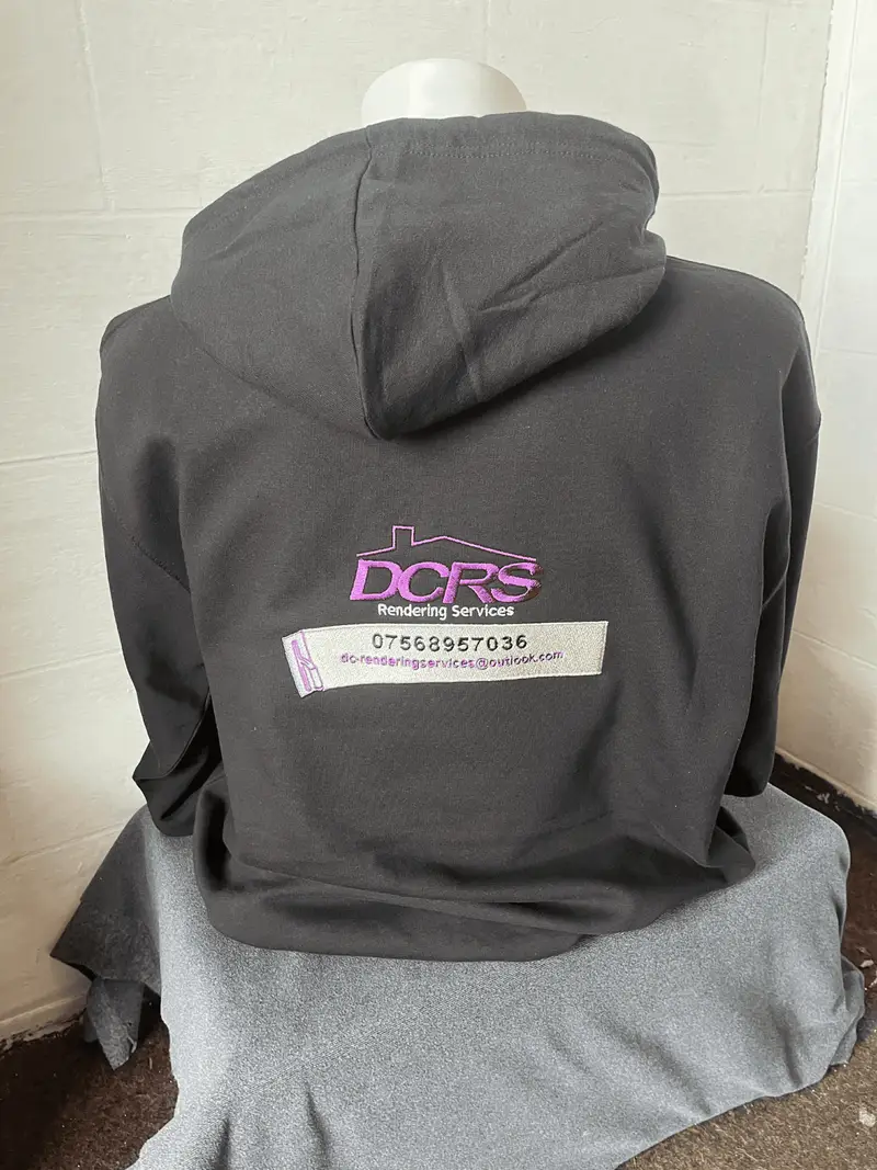 Grey hoodie printed with the DCRS Rendering Services logo and contact details