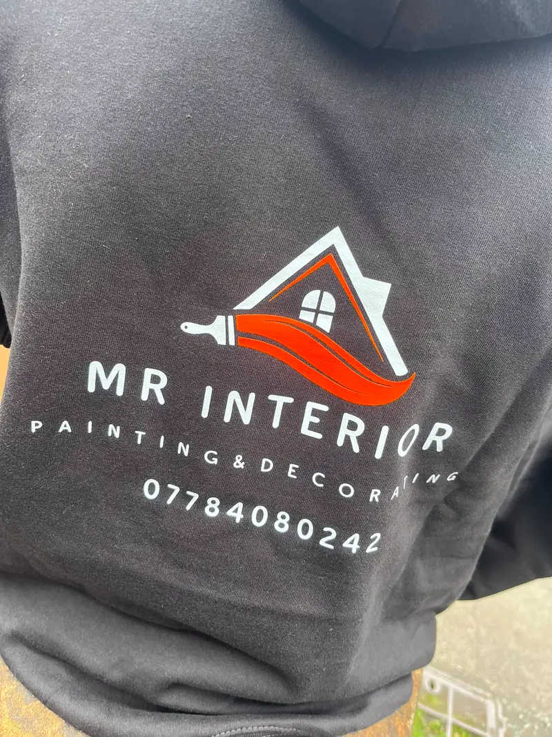 Grey hoodie printed with the Mr Interior painting and decorating logo