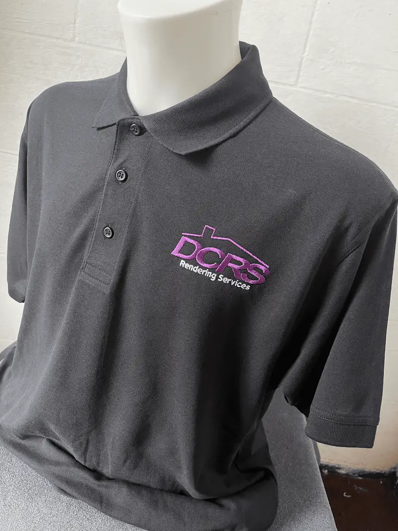 Grey polo shirt embroidered with the DCRS Rendering Services logo