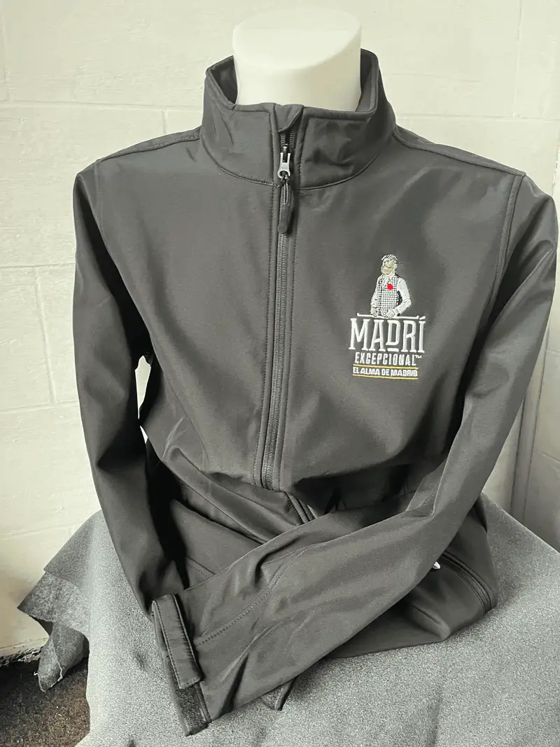 Grey softshell jacket embroidered with the Madrí Excepcional logo for bar staff