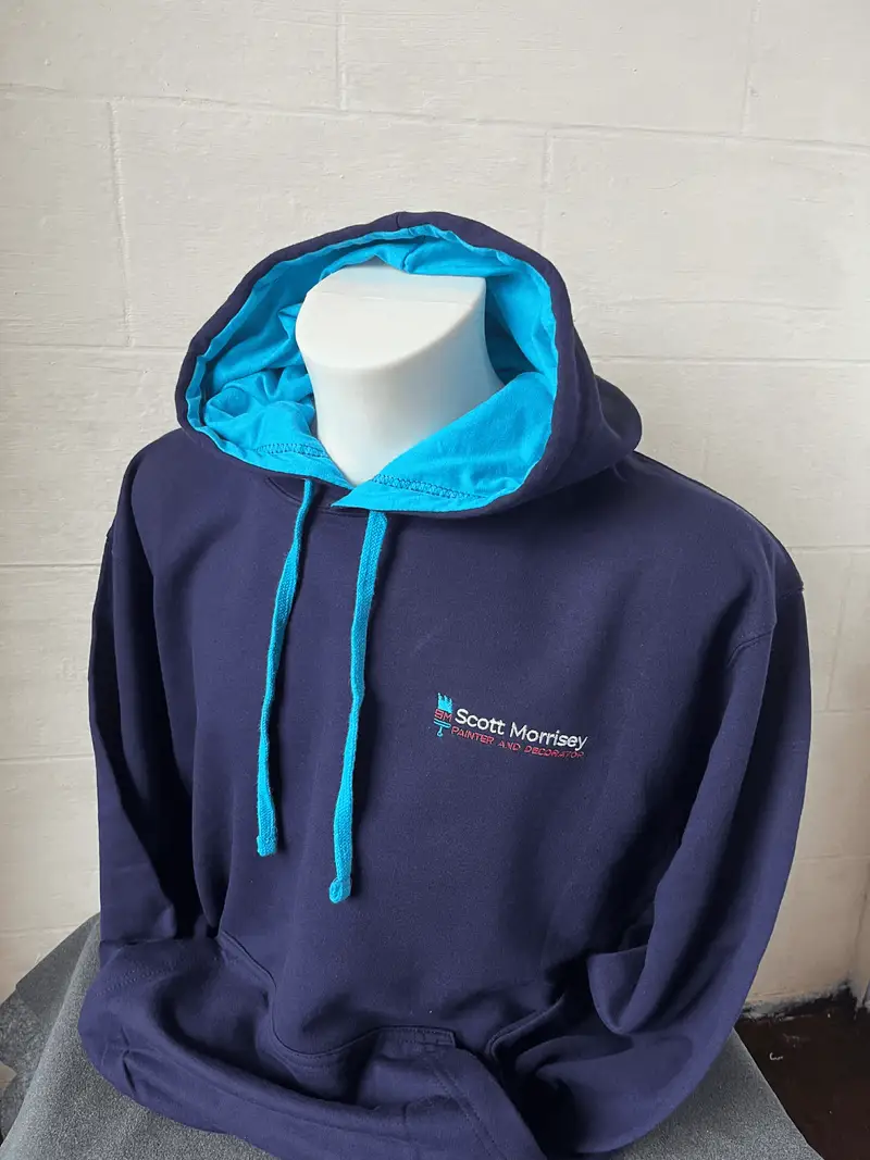 Navy and turquoise hoodie embroidered with the Scott Morrisey logo
