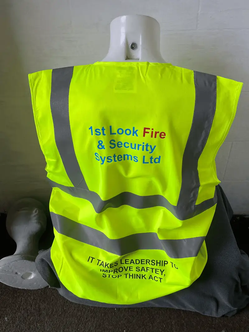 Yellow hi-vis vest printed in Colne with the 1st Look Fire & Security logo and a site safety slogan