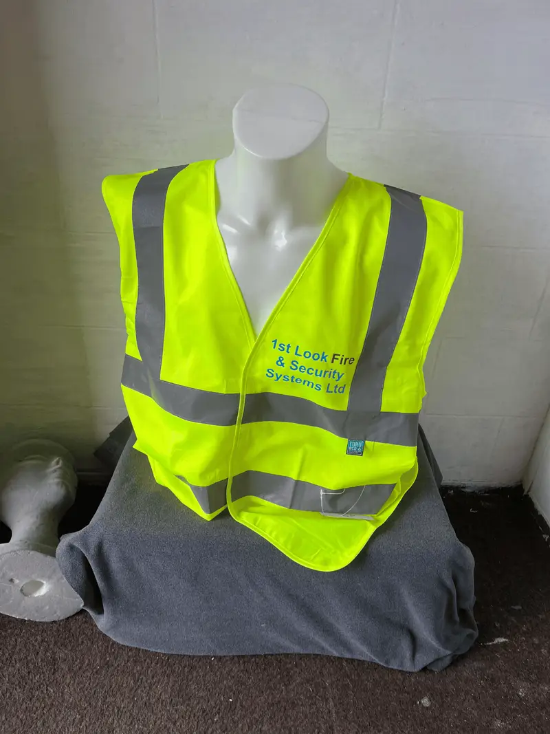 Yellow hi-vis vest printed with the 1st Look Fire and Security logo