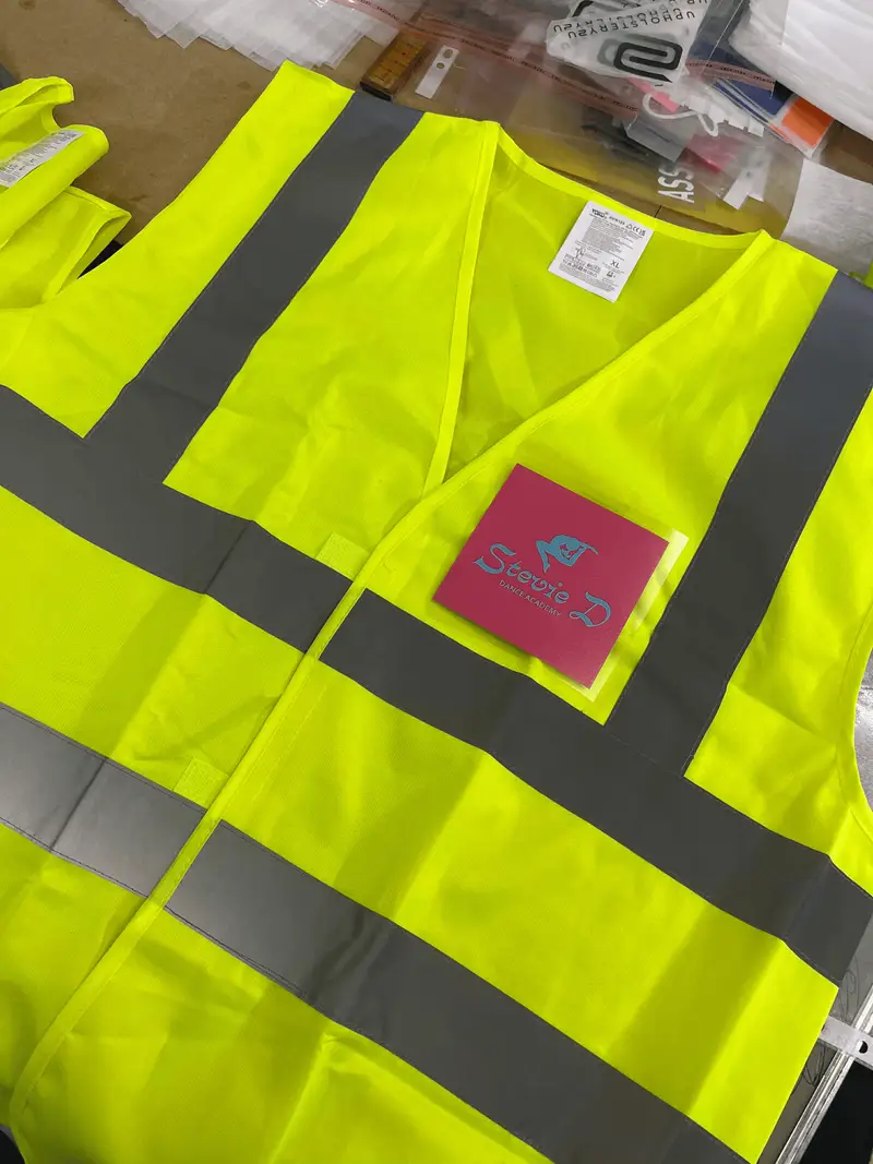 Yellow hi-vis vests with a pink Stevie D branded badge